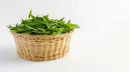 Fototapeta premium Fresh Green Tea Leaves in a Woven Basket on a Minimalistic Background Ideal for Herbal Tea, Natural Ingredients, and Organic Products Promotion