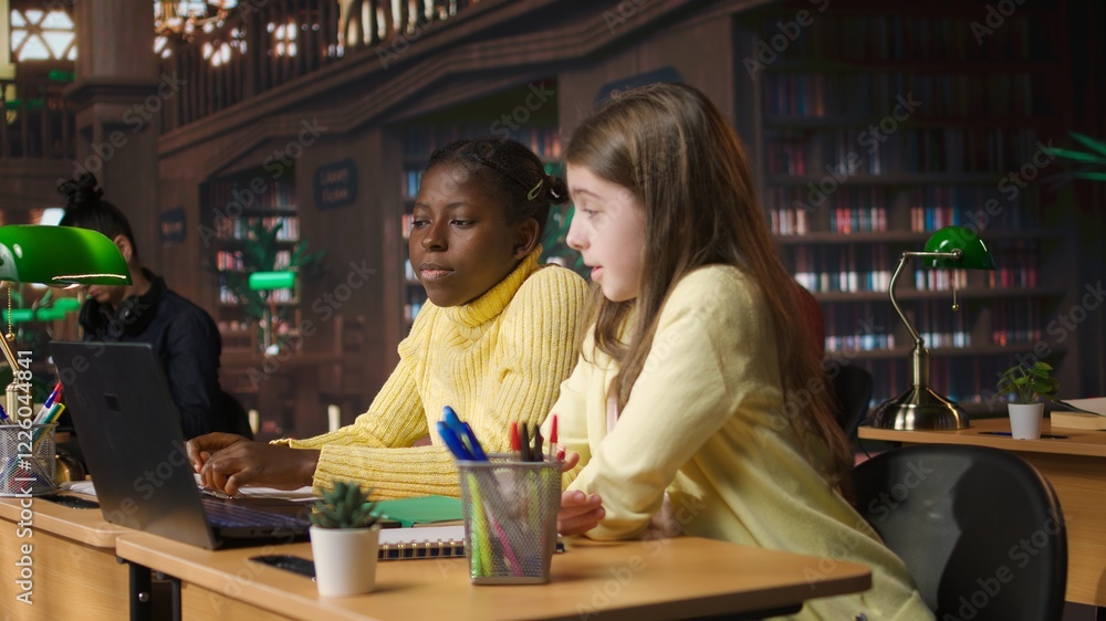 Poster primary school pupils in a library discuss during an online seminar, using tech to connect with educ