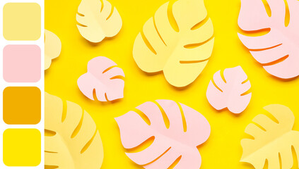 Paper tropical leaves on yellow background