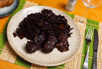 Delicious pork ribs stewed in gravy with sauerkraut closeup