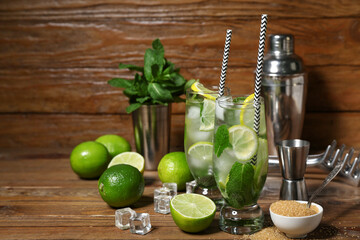Glasses of cold mojito on wooden background