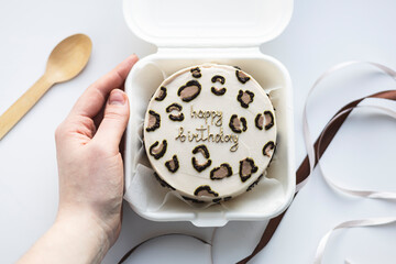 Mini bento birthday cake in a takeout box with decorative spoon