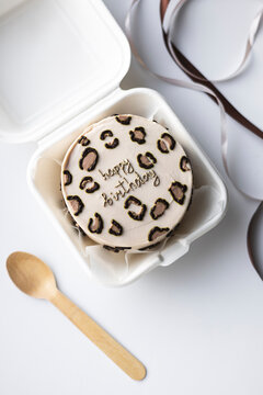 Top view of a bento birthday cake in a takeout box