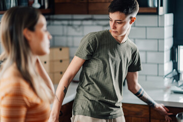 Lesbian couple arguing in kitchen during difficult conversation