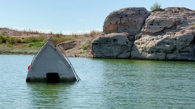Drought-stricken Lake Mead reveals haunting bow of sunken vessel, emerging from receding waters, highlighting environmental crisis and hidden artifacts in Nevada's largest reservoir.
