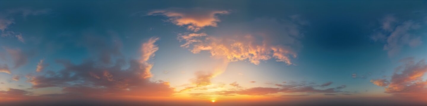 Dramatic sunset panorama shows vivid colors in dark blue sky. Cirrus clouds add texture to sky. View from high altitude. Great image for 3D visualization, game backgrounds, sky replacement in aerial