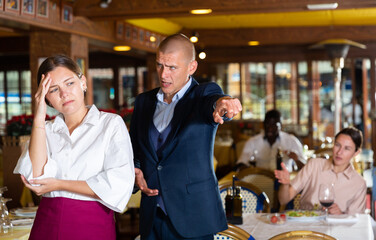 Upset waitress having conflict with manager displeased by poor work quality