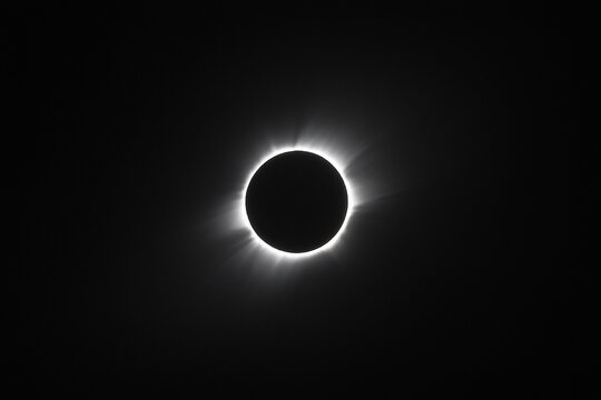 Total solar eclipse showcasing the moon covering the sun with solar corona visible in the background