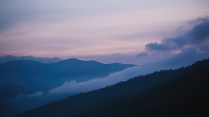 Fototapeta premium Serene mountain landscape with misty hills at dusk