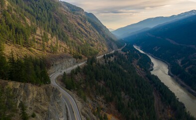 Trans Canada Highway winding through a mountain valley, cars travel along the scenic route. Autumn...