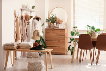 Interior of clothing store office with table, mannequin and rack