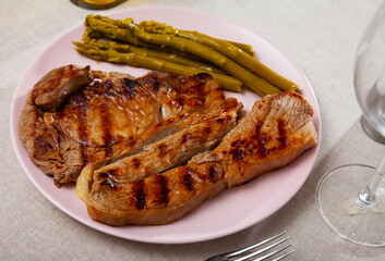 Appetizing beef steak with asparagus on plate