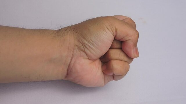 Close-Up Video of Human Hand Transitioning from Open Palm to Clenched Fist on White Background