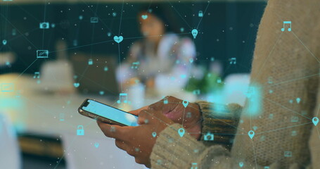 Image of media network over hands of african american man using smartphone at casual office