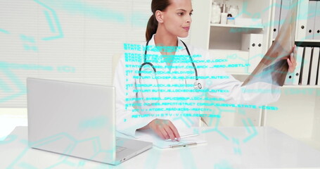 Image of blue data processing over biracial female doctor working at desk with x ray and laptop