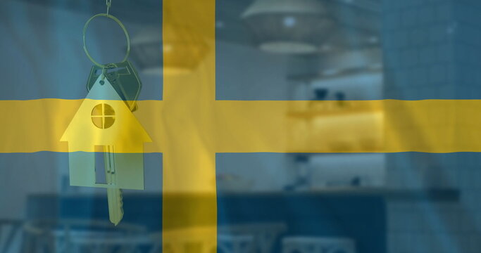Image of silver house key over waving flag of sweden and office building