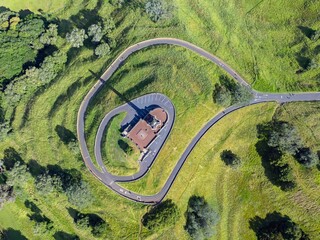 High-angle view of a winding road around a historical monument. Park visitors enjoy the scenic...