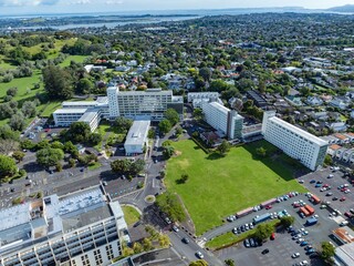 High-angle view of Auckland hospital complex, parking lots, and surrounding residential areas. Urban landscape with various buildings and green spaces. GREENLANE HOSPITAL, AUCKLAND, NEW ZEALAND