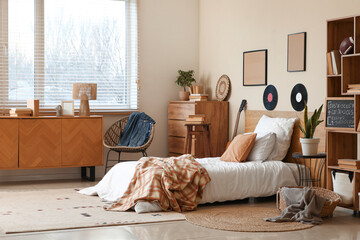 Interior of teenager's room with bed, vinyl disks and drawers