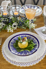 Stuffed Pear on a bed of spinach with a pecan nut on a bed of goat cheese