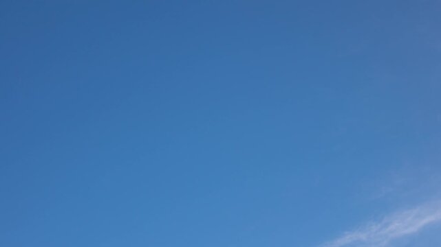 White clouds moving fast from right to left time-lapse. Daylight cloudy heaven background. Long timelapse light clouds transforming in blue sky with motion blur. Perfect for text, titles, logo