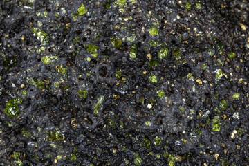 Closeup, raw peridot in volcanic rock matrix. From beach on the island of Hawaii, near South Point....