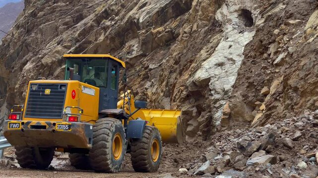 Bulldozer clearing landslide debris from JSR Road in Skardu, Pakistan, restoring accessibility and facilitating safe passage