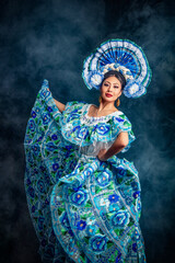 A woman in a blue dress with flowers on it is dancing