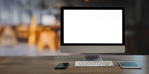 A computer monitor sits on a desk Blank screen desktop computer in minimal room with decorations and copy space © onephoto