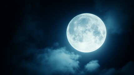 Bright full moon illuminating a night sky with scattered clouds, creating a serene atmosphere