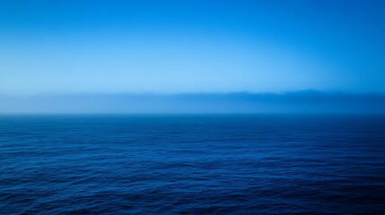 Obraz premium Serene Ocean Mist Under a Blue Sky