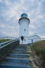 Father and son walking up stairs to light house