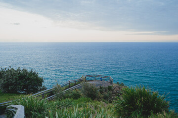 Tiny person at look out in front of vast open ocean