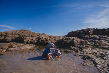 Two kids exploring rock pools