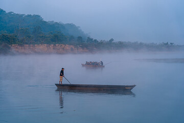 Tourist baoting on Rapti river in Sauraha, Chitwan, Nepal.