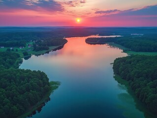 Fototapeta premium Aerial View of Tranquil Lake at Sunset Vibrant Sky Reflections Peaceful Village Lush Forests Poland
