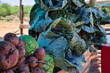African village stand, selling vegetables from a wooden shack stall in the city, on the side of the...