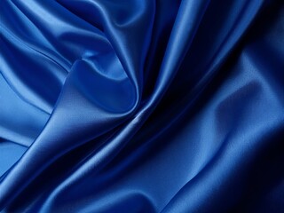 Obraz premium A luxurious deep blue silk satin fabric with elegant, soft wavy folds. The fabric has a liquid wave effect, reflecting light beautifully. A rich navy blue tone dominates the scene