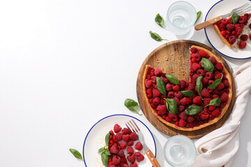 Berry pie on plates, towel and glasses on white background, space for text