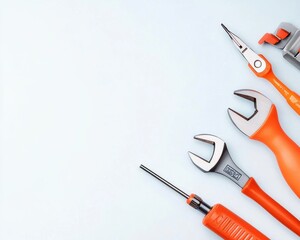A collection of orange-handled tools arranged neatly against a light background, showcasing various types of hand tools for DIY and repair tasks.