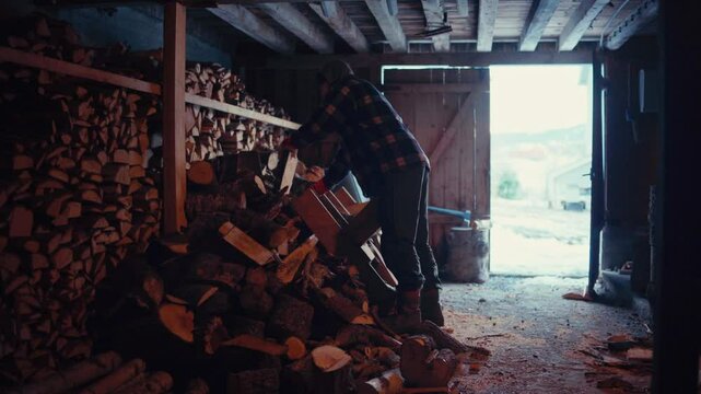 A Man Inside The Stacked Log Cabin Shed. Static Shot