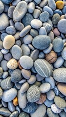 Smooth beach stones create a serene grey pebble landscape under natural light