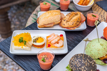 Delicious assortment of brunch items served outdoors on a sunny day.