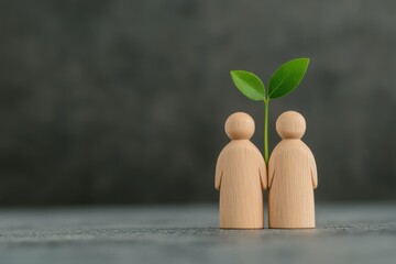 Close Up of Wooden Figurines with Green Leaves Symbolizing Care, Growth, and Connection Against a Soft Background