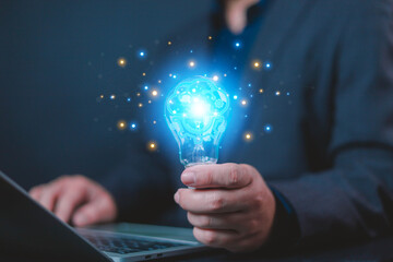 Idea great innovate and concept. Businessman holding a light bulb shines in front of the laptop, Presenting innovative and inspiring ideas and technology, Light bulb, idea, goal