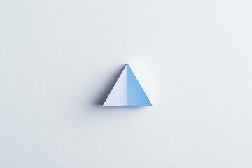 A minimalist paper pyramid in blue and white on a clean white background, symbolizing creativity and design