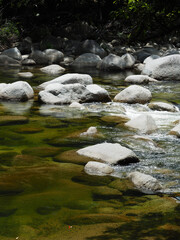 close up of mossman gorge flowing through rocks in port douglas 