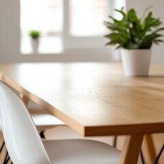 Modern light wood dining table with white chairs and plant.
