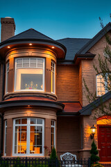 Luxury Home Exterior at Night: Brick Facade, Elegant Design, Warm Lighting