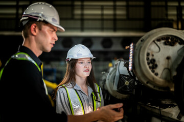 Factory engineers inspect on machine. Confident team mature businessman with laptop standing by robotic arm in industry businessman inspect at height technology for produce the electronic part device.